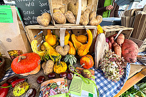Das Bild zeigt einen Marktstand mit regionalen Produkten.